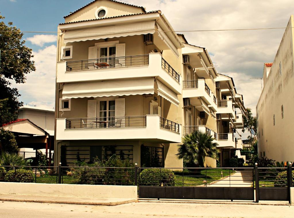 a large white building with aventh floor at Diavlos Studios in Agiokampos