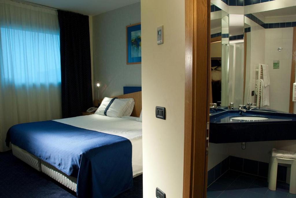 Postel nebo postele na pokoji v ubytování Hotel Mastai