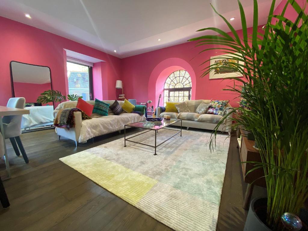 a living room with a couch and a table at Sublime waterfront retreat with private terrace in Bristol