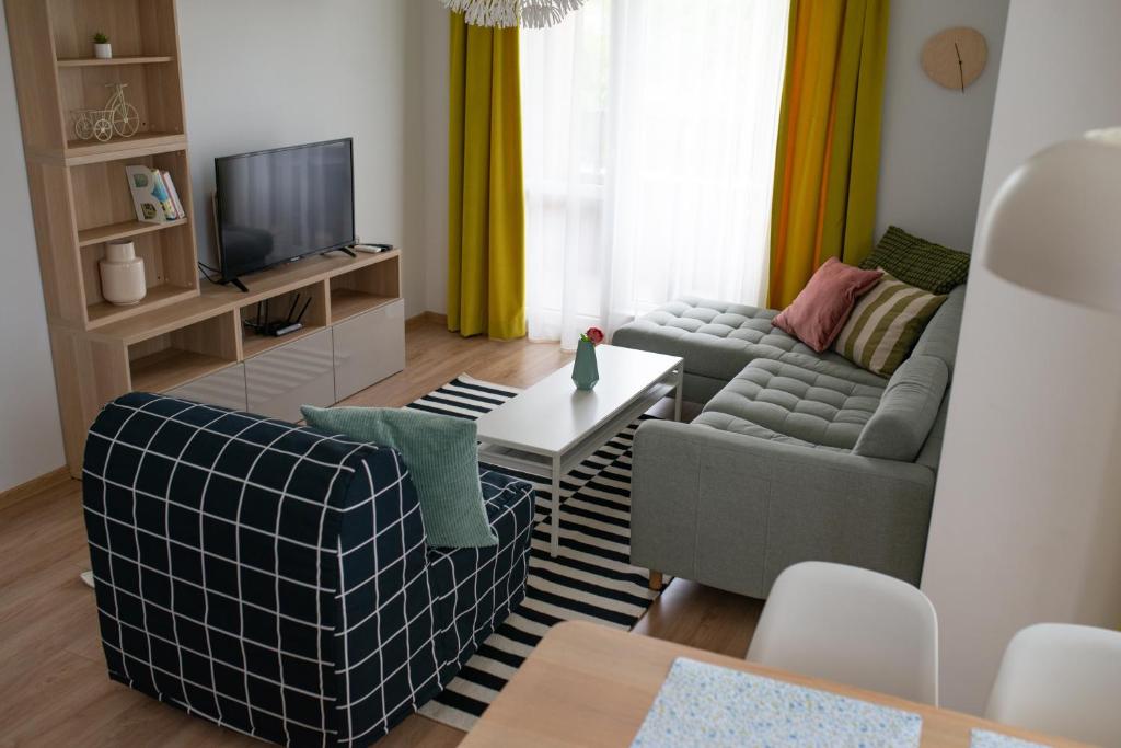 a living room with two couches and a tv at Apartment next to Mall Plovdiv in Plovdiv