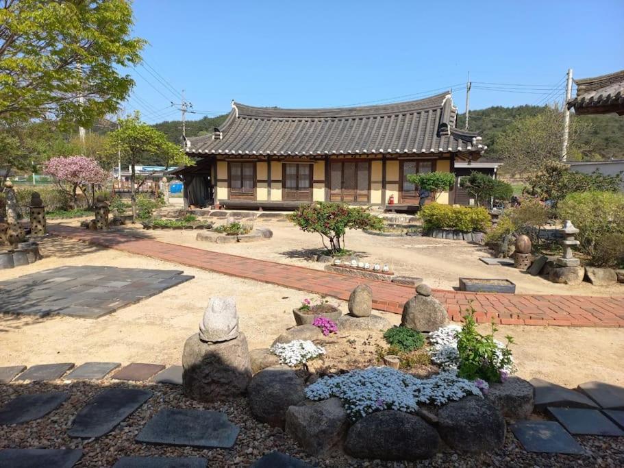 un jardín frente a una casa con un edificio en Yasun Gallery, en Gyeongju