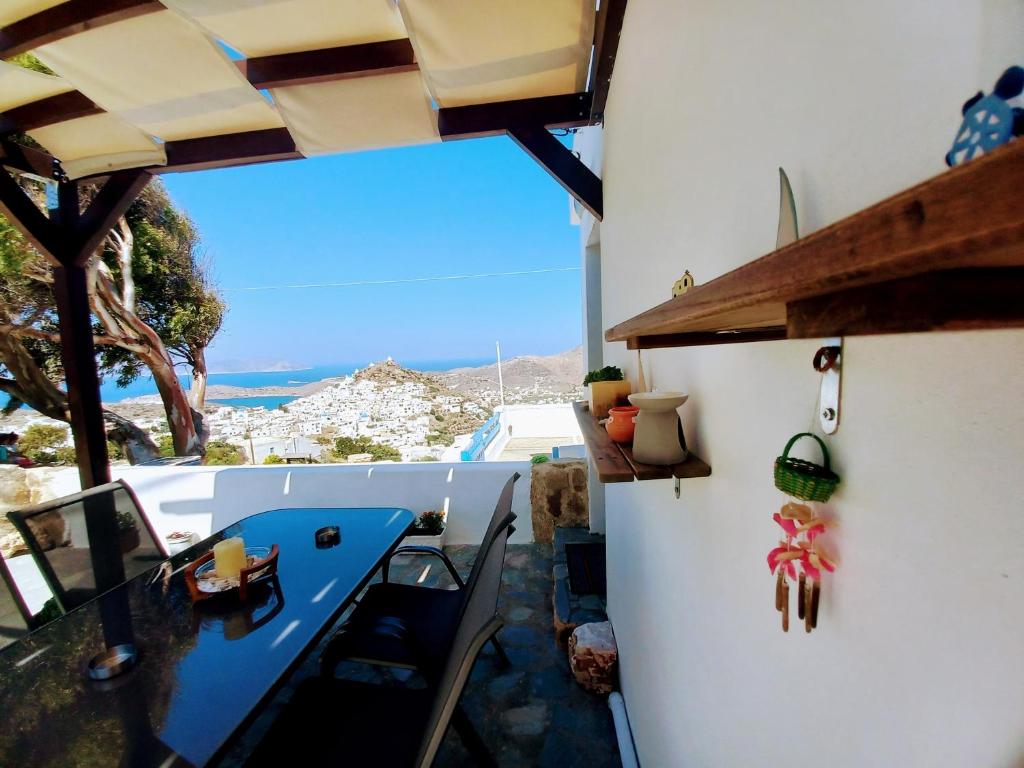 a kitchen with a blue table and a view of the ocean at M.V.G.M.-Home in Ios Chora
