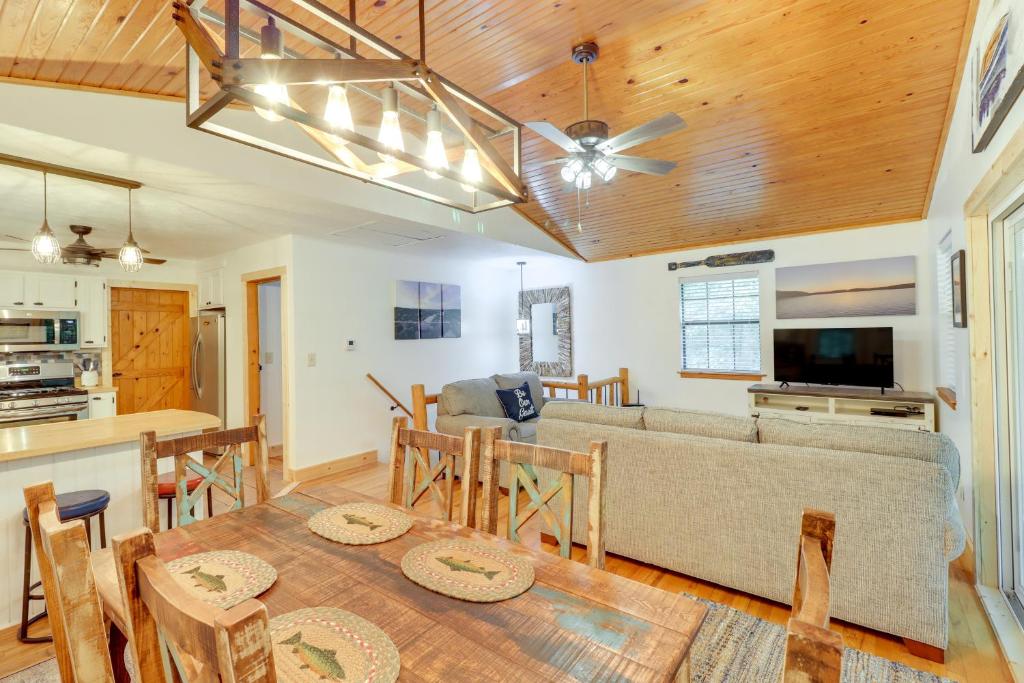 a living room with a couch and a table at Woodsy Gassville Getaway about 3 Mi to White River! in Gassville