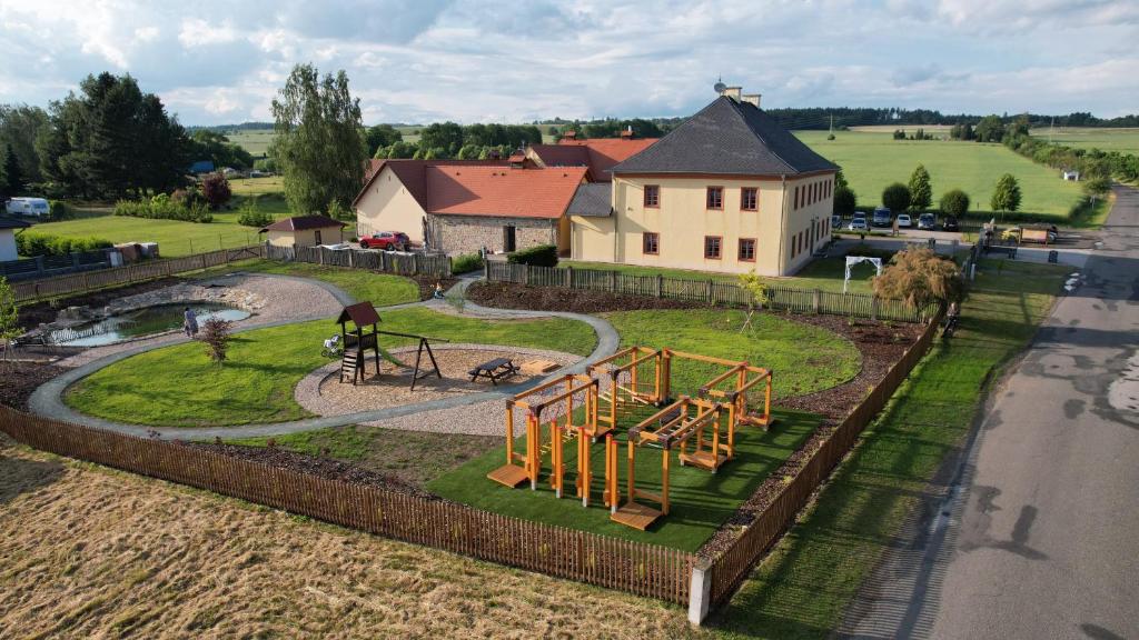 an aerial view of a playground in front of a house at Penzion na Faře in Dubenec