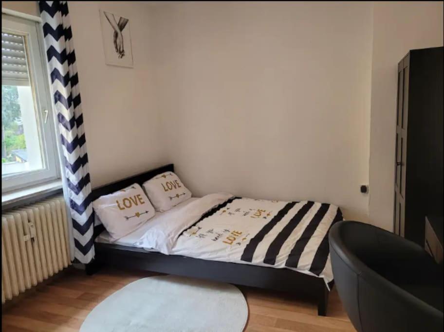 a small bedroom with a bed with two pillows on it at Wohnung im Zentrum von Darmstadt in Darmstadt