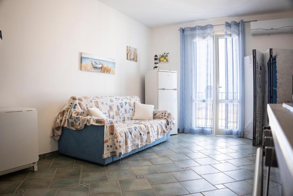 a living room with a couch and a refrigerator at HIERA CASAVACANZE in Marettimo