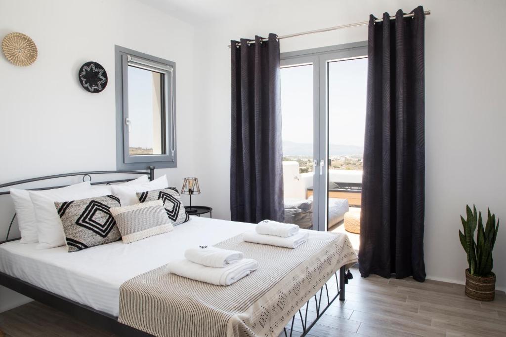 a bedroom with a bed with two towels on it at Naxos King Villa in Galanádhon