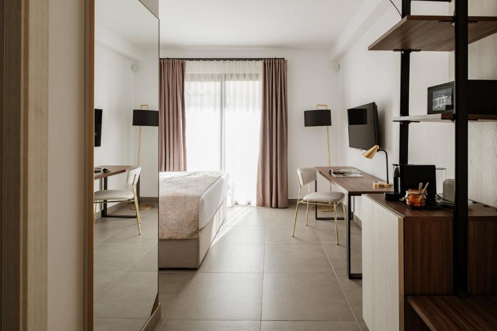 a hotel room with a bed and a desk at 1926 Le Soleil Hotel & Spa in Sliema