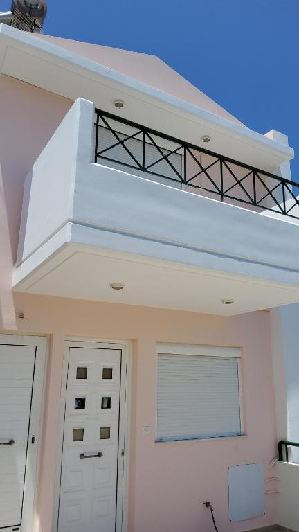 a white house with a staircase on top of it at orange in Ialyssos