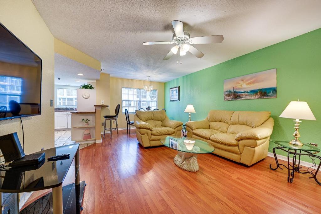 a living room with two couches and a ceiling fan at Florida Vacation Rental Condo Near Tampa in Lutz