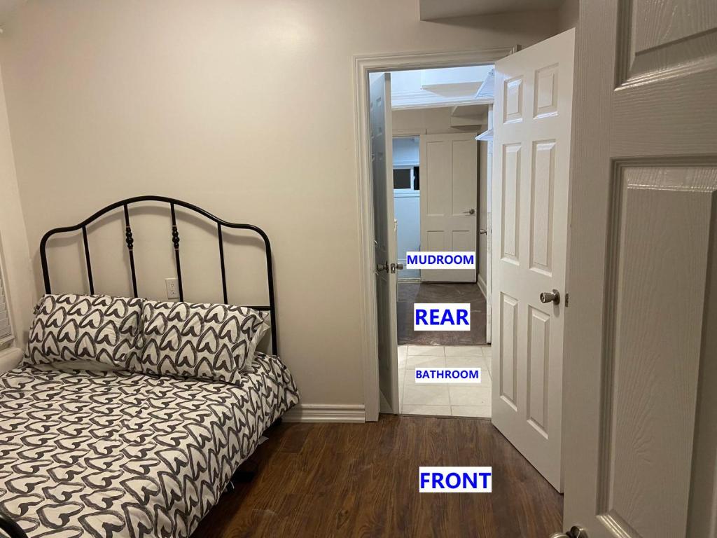 a bedroom with a bed and a room with a door at Quad Room with En Suite Bathroom 0362 in Toronto