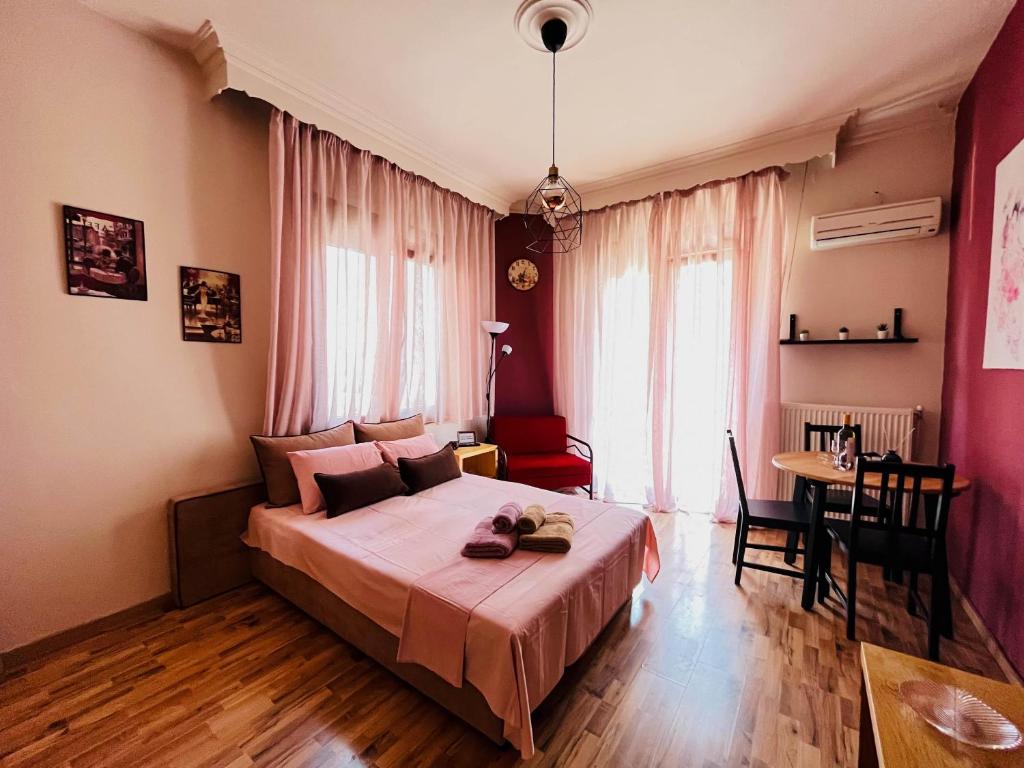 a bedroom with a bed and a table in a room at Studio in the Center in Kavala