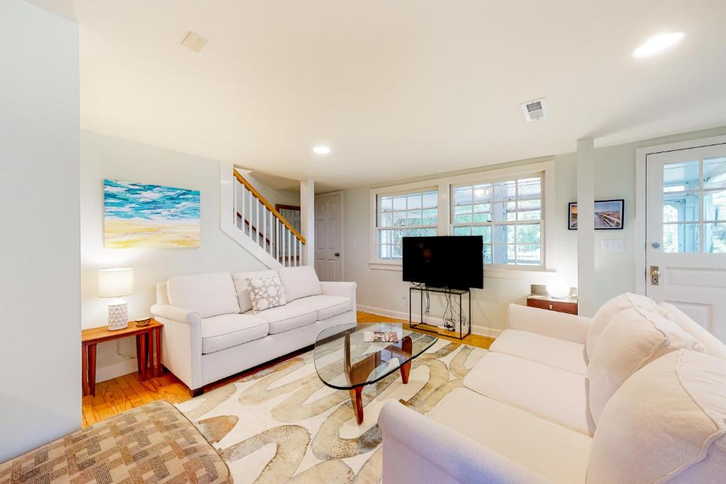 a living room with white furniture and a flat screen tv at Town of Rehoboth Beach 44 Henlopen Ave in Rehoboth Beach