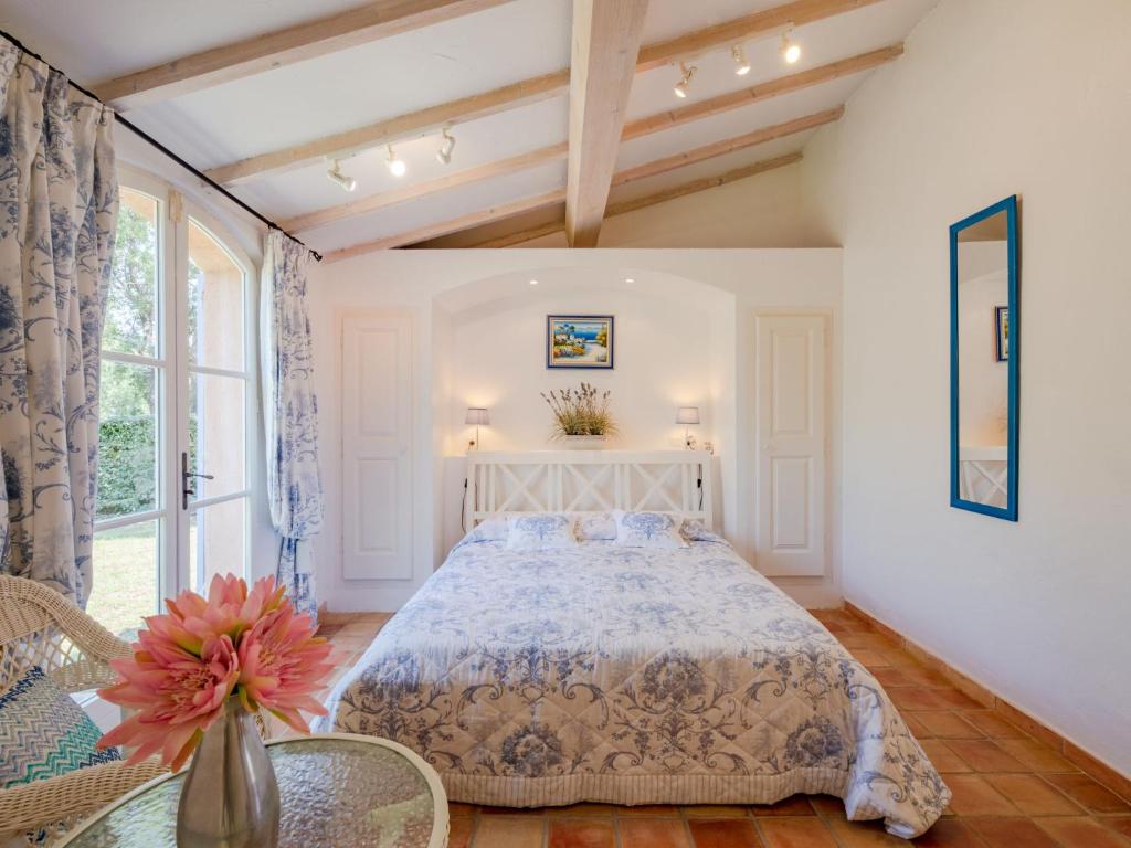 a bedroom with a large bed and a table at Holiday Home La Bastide Rose by Interhome in Sainte-Maxime