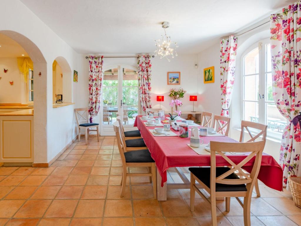 a dining room with a red table and chairs at Holiday Home La Bastide Rose by Interhome in Sainte-Maxime
