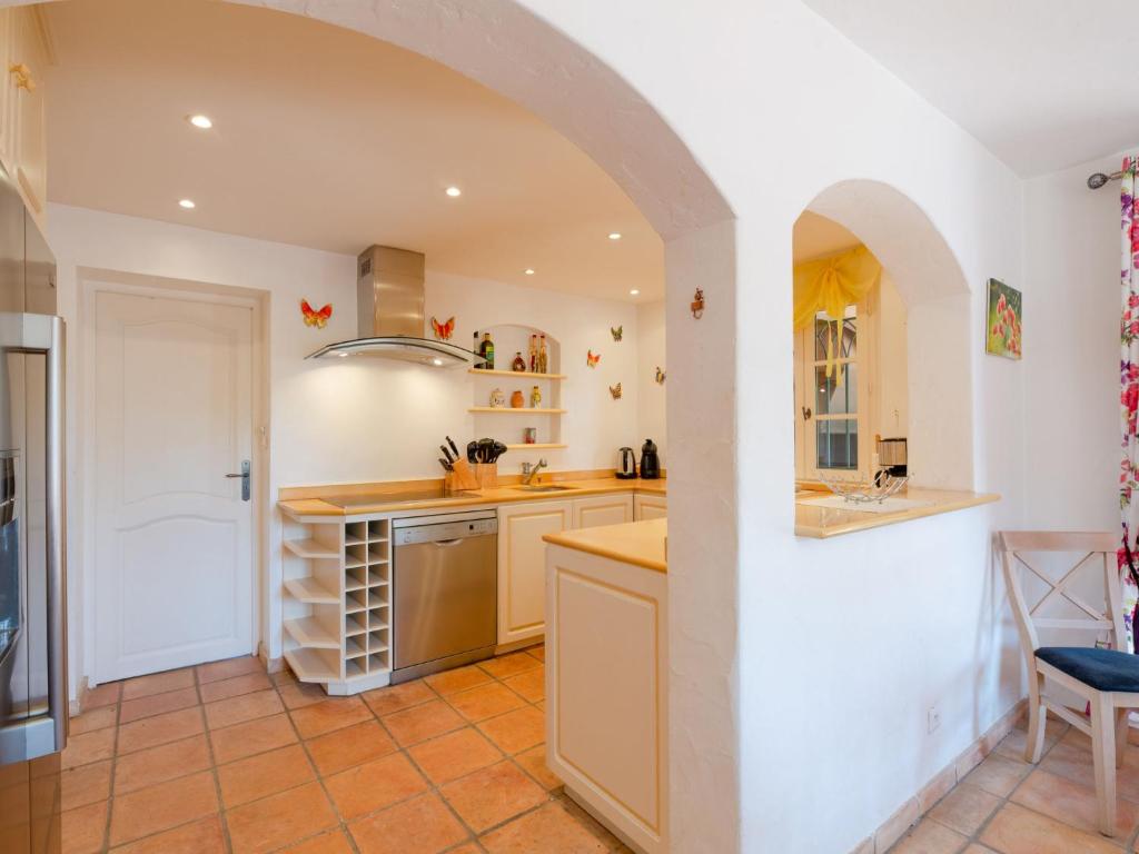 a kitchen with a counter and a sink and an archway at Holiday Home La Bastide Rose by Interhome in Sainte-Maxime