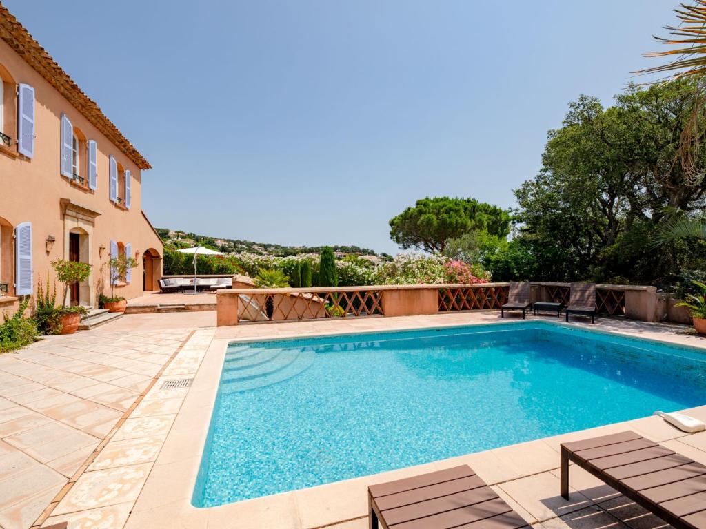 a swimming pool in the backyard of a house at Holiday Home La Bastide Rose by Interhome in Sainte-Maxime