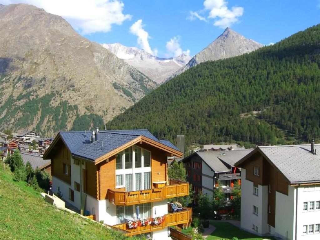 a house on a hill with mountains in the background at Apartment Schtraffel by Interhome in Saas-Fee