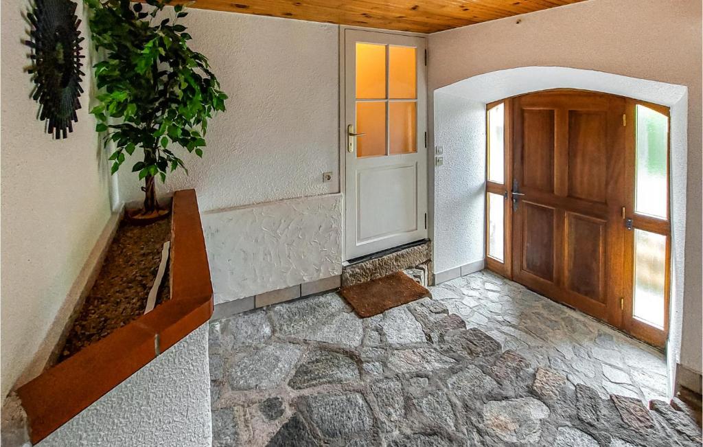 an empty hallway with a door and a plant at Amazing Home In Essertines-en-chtelne With 3 Bedrooms in Essertines-en-Châtelneuf