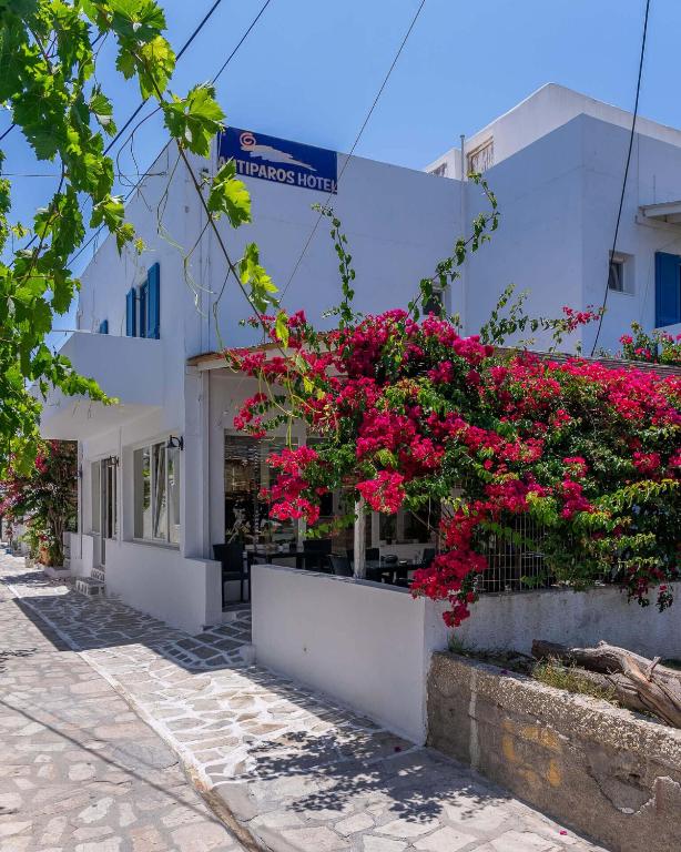 a building with pink flowers on the side of a street at Hotel Antiparos in Antiparos Town