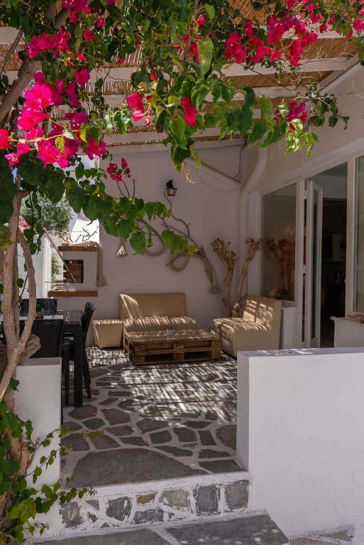 a living room with pink flowers and a couch at Hotel Antiparos in Antiparos Town