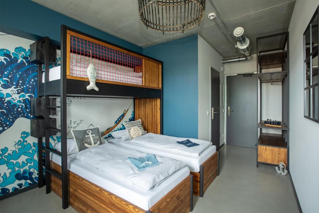 a bedroom with two bunk beds and a blue wall at Surf Rescue Club in Grömitz