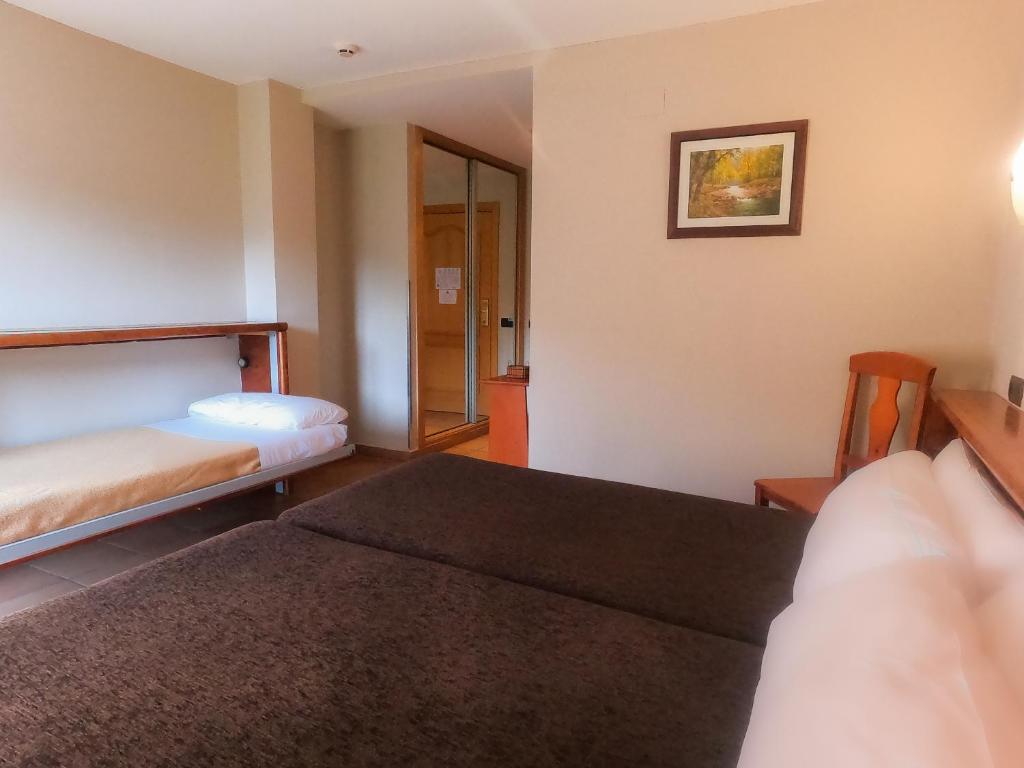 Кровать или кровати в номере Hotel Ransol