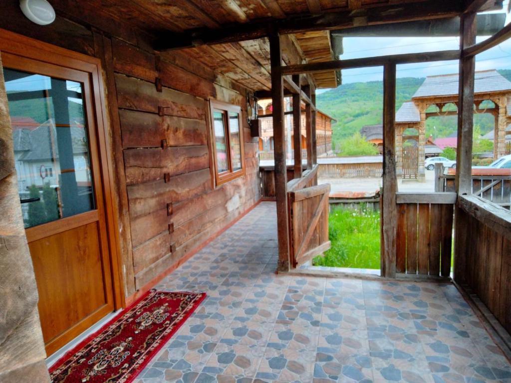 an inside view of a wooden house with a porch at Casa Godja Oncesti in Onceşti