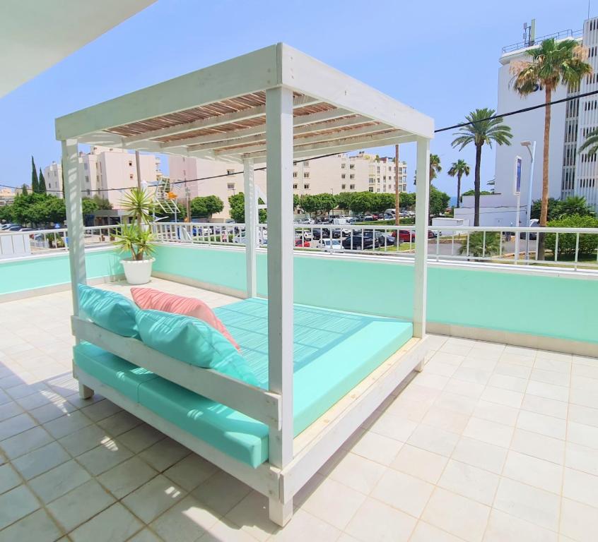 a bed on the roof of a building at Tabbu ibiza apartments in Playa d'en Bossa