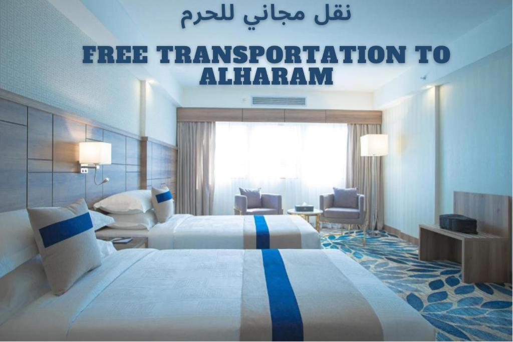 a hotel room with two beds and a sign that reads free transportation to almingham at Season Star Hotel Madinah in Medina