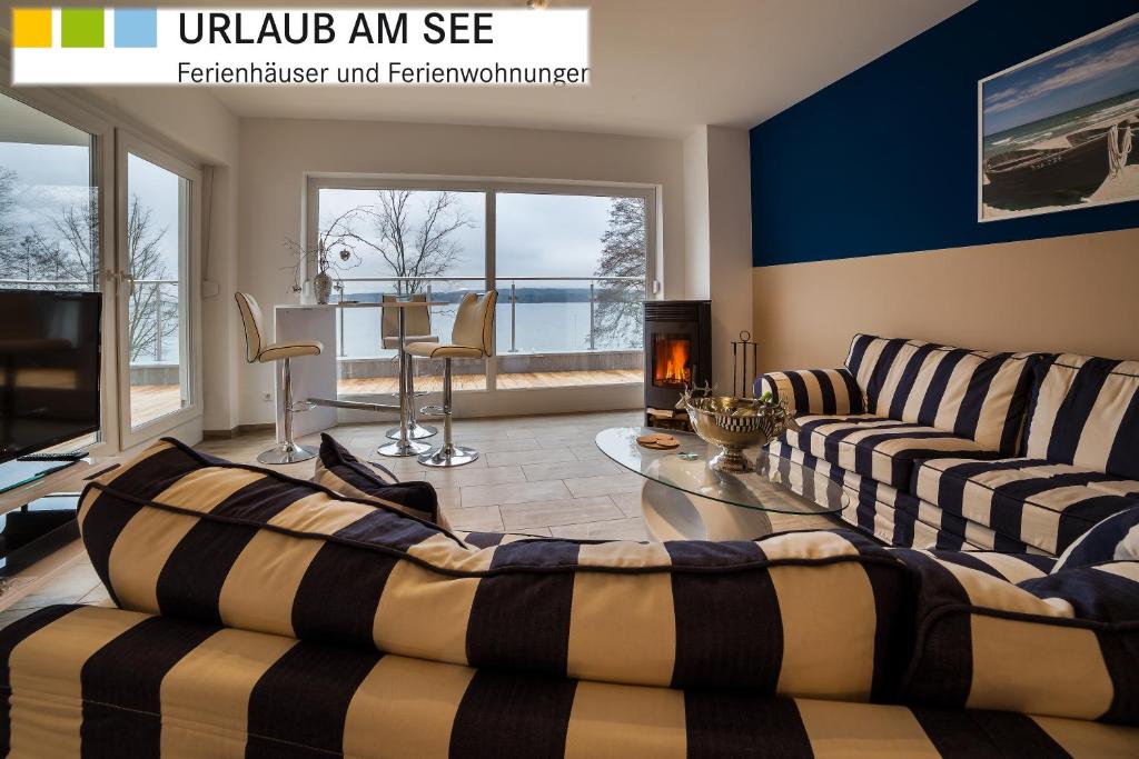 a living room with two couches and a table at Charming Apartments am See in Bad Saarow