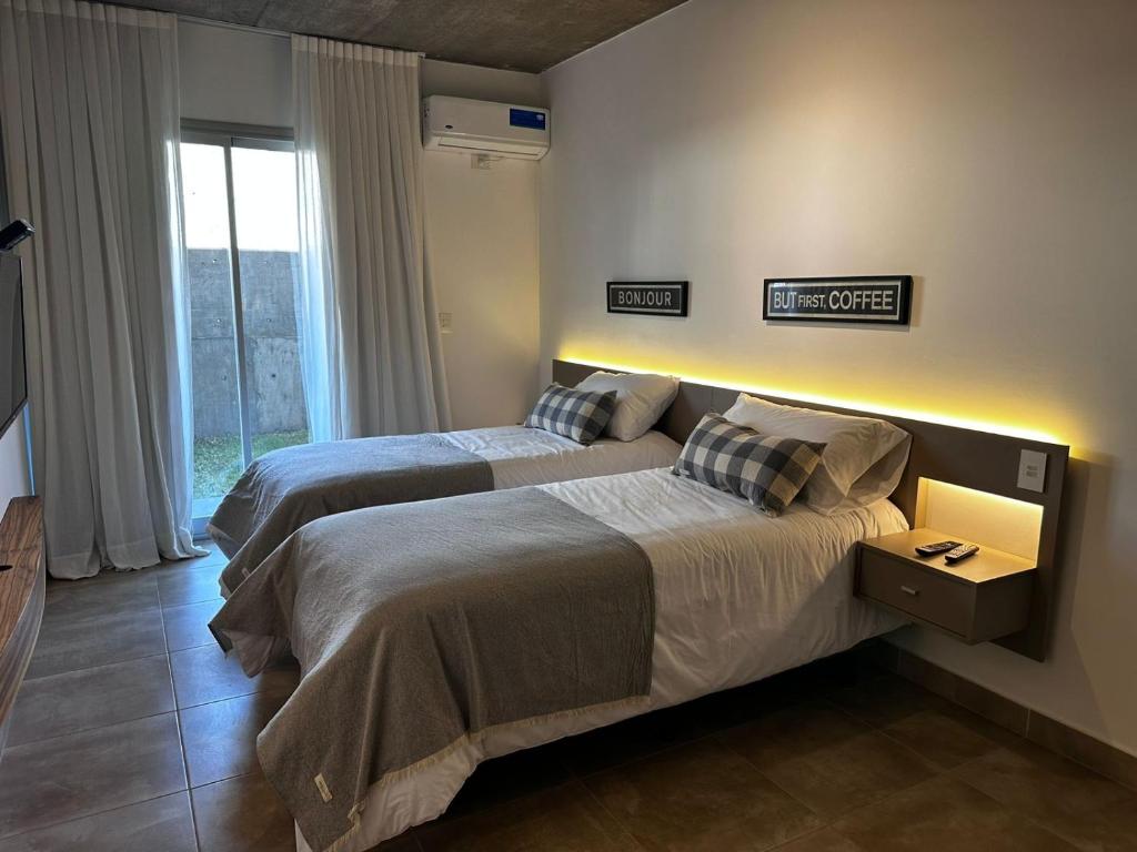 a bedroom with two beds and a window at Rentarte in Pilar