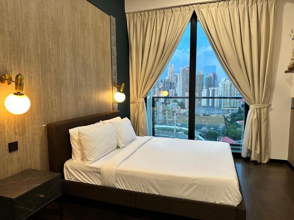 a bedroom with a bed and a large window at Millennium Suite At Opus Residence in Kuala Lumpur