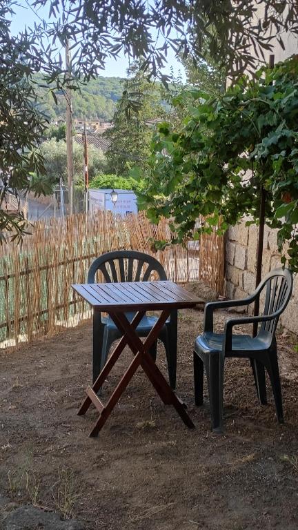 a picnic table and a chair next to a table and a bench at El Olivar in La Adrada