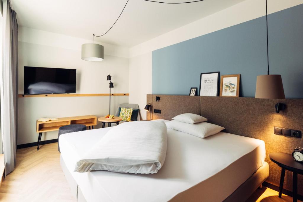 Postel nebo postele na pokoji v ubytování harry's home Berlin-Moabit hotel & apartments