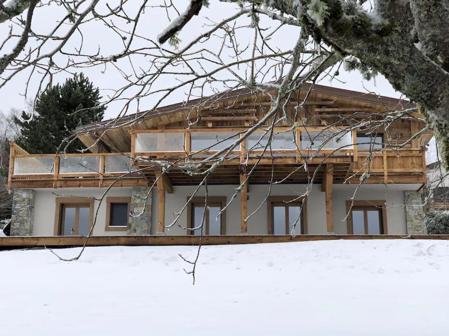 a house under construction with snow in front of it at Chalet 14p vue lac, spa et sauna in Gérardmer