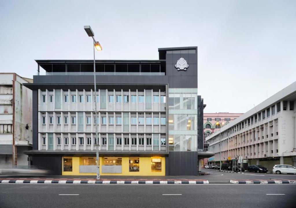 a building with a clock on the side of it at The Brunei Hotel in Bandar Seri Begawan