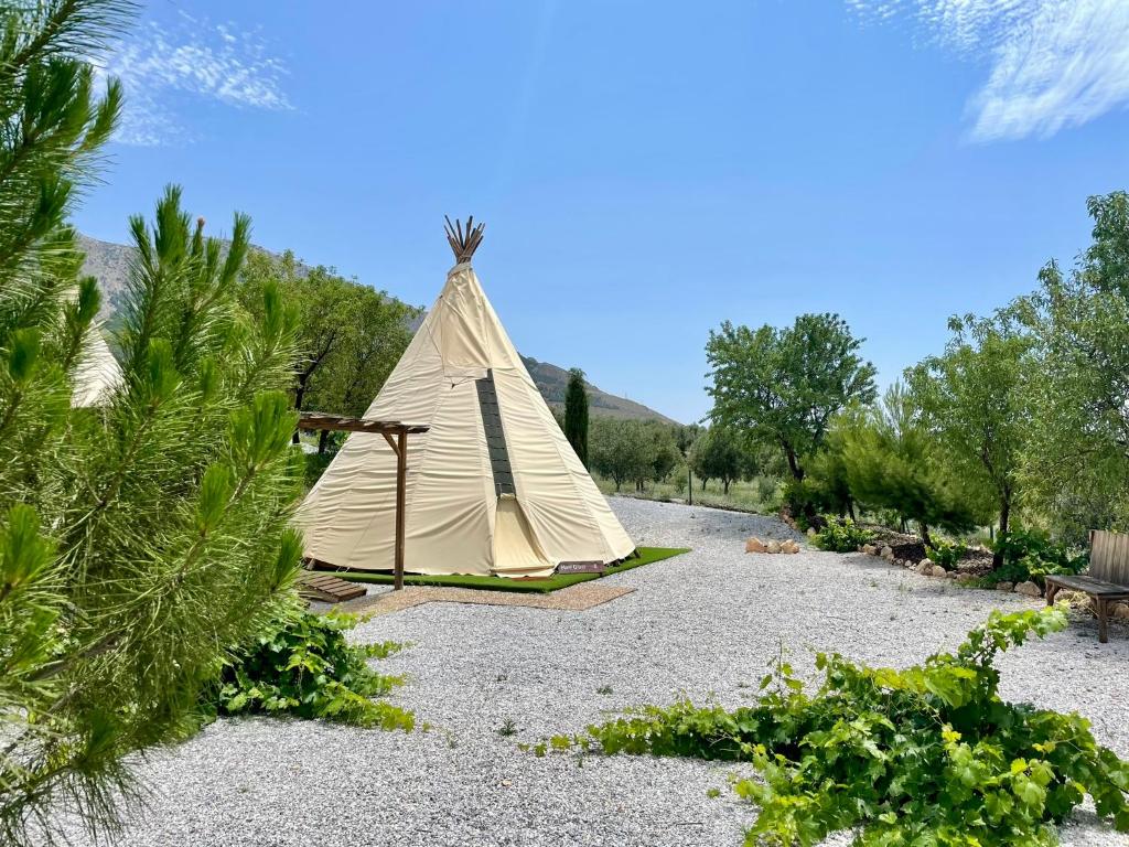 a teepee tent in the middle of a garden at Boutique Teepee Sleeps 2 with Pool in Zújar