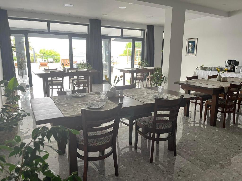 a dining room with tables and chairs and windows at Dela in Hvar
