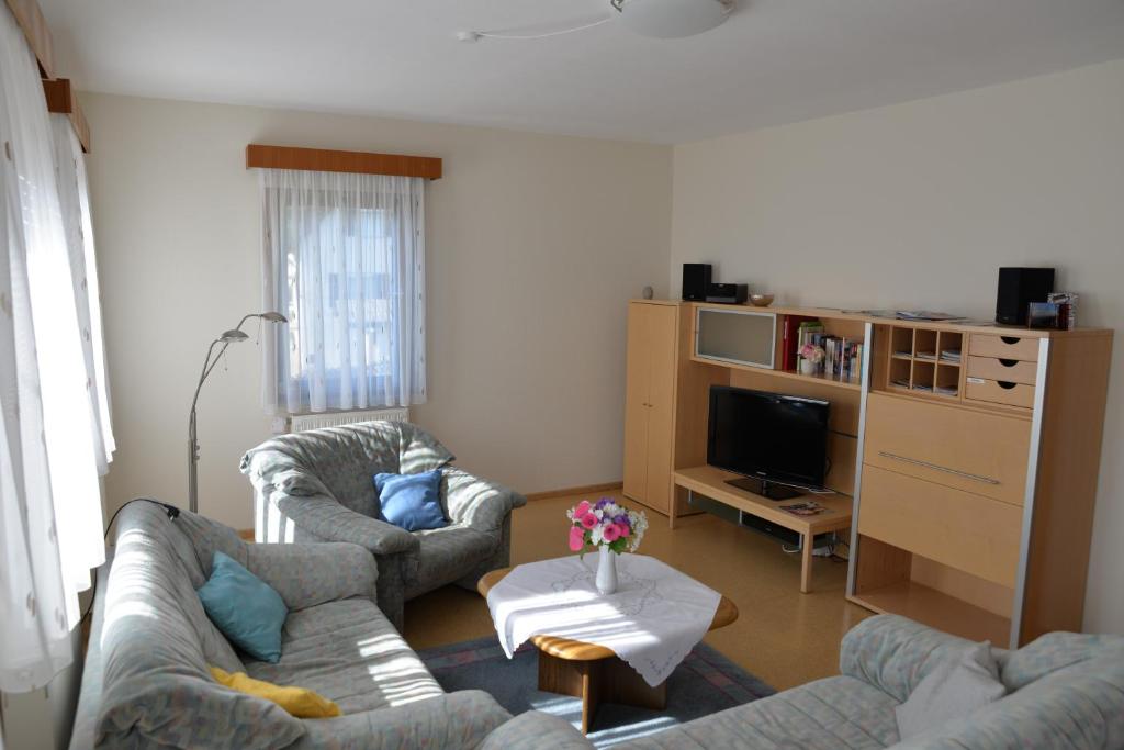 a living room with two couches and a tv at Ferienwohnung Dürnbach in Albstadt