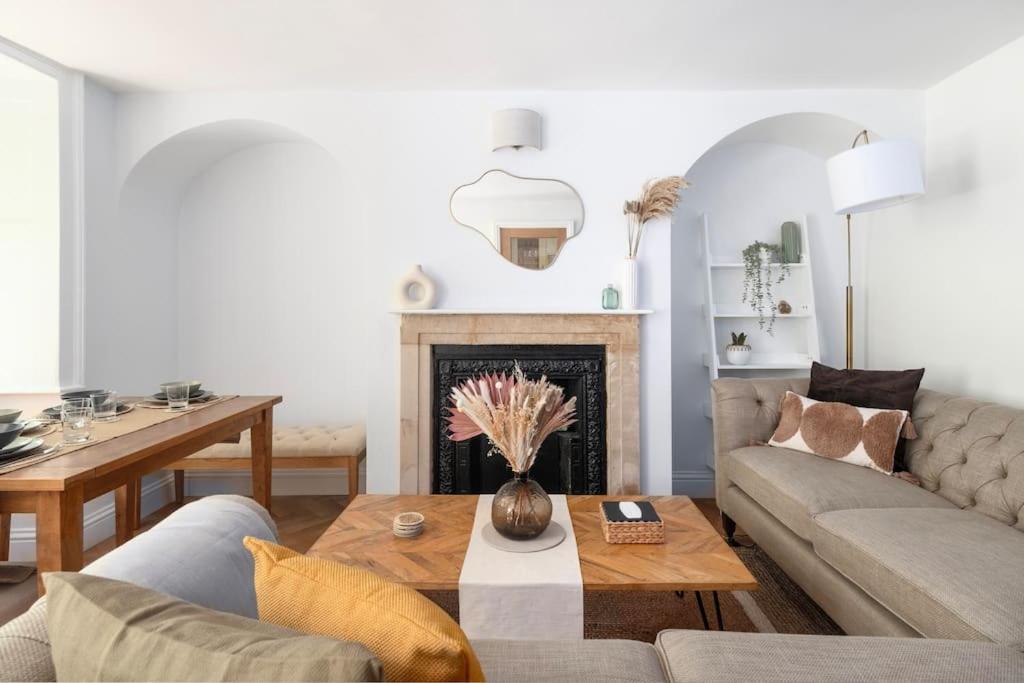 a living room with a couch and a table at Newly Renovated City Apartment in Bath