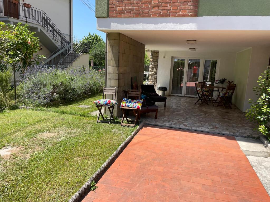 a patio with chairs and a table and a house at My Bnb Pisa in Pisa