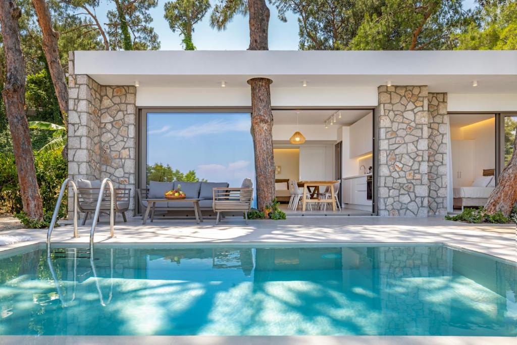 a house with a swimming pool and a patio at Aegean View Estate - Villa in Faliraki