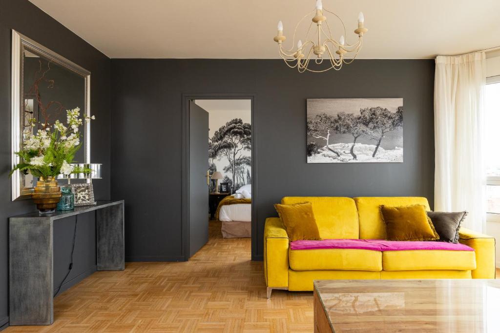 a living room with a yellow couch and a table at DIFY Duguesclin - Quai du Rhone in Lyon