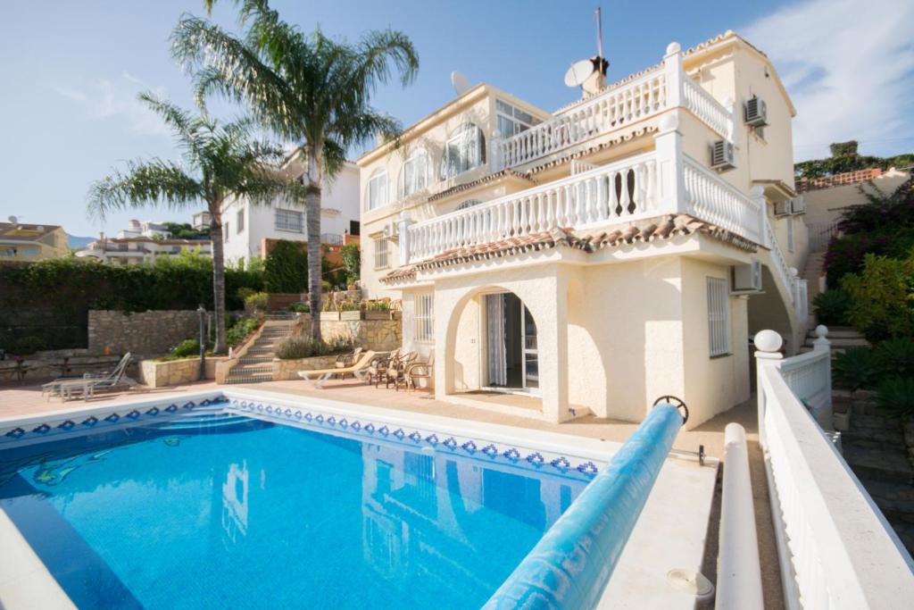 a large white house with a swimming pool at Villa Janina in Fuengirola