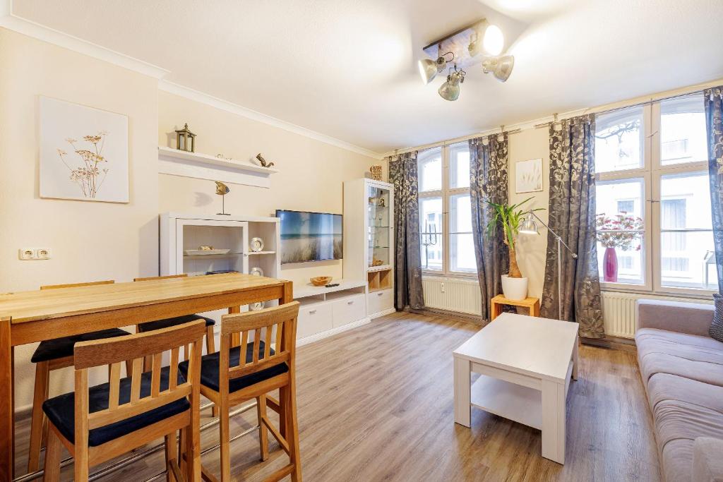 a living room with a table and a couch at Ferienappartements Stralsund in Stralsund