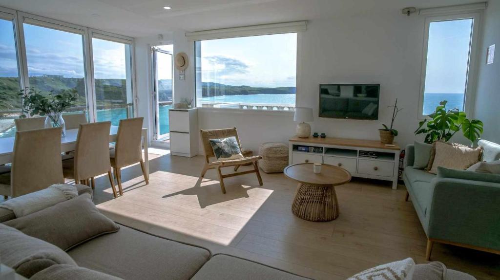 a living room with a couch and a table at Apartamento Sunset con vistas Playa de Los Locos in Suances