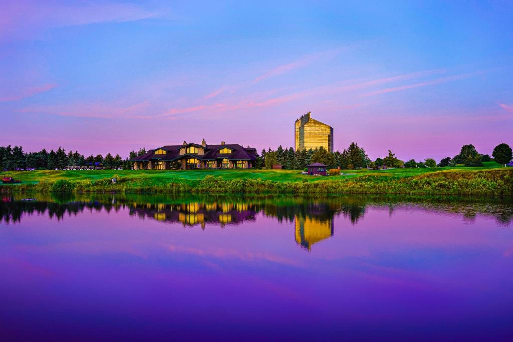 a building next to a lake in front of a building at Grand Traverse Resort and Spa in Traverse City