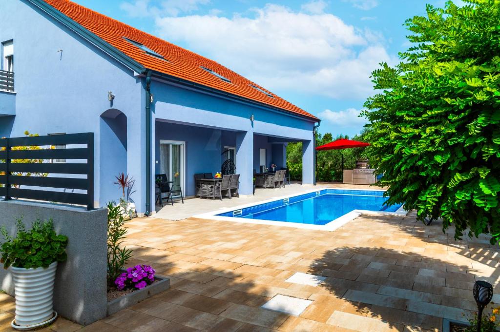 a house with a swimming pool in a yard at SunSplash Sanctuary in Šibenik