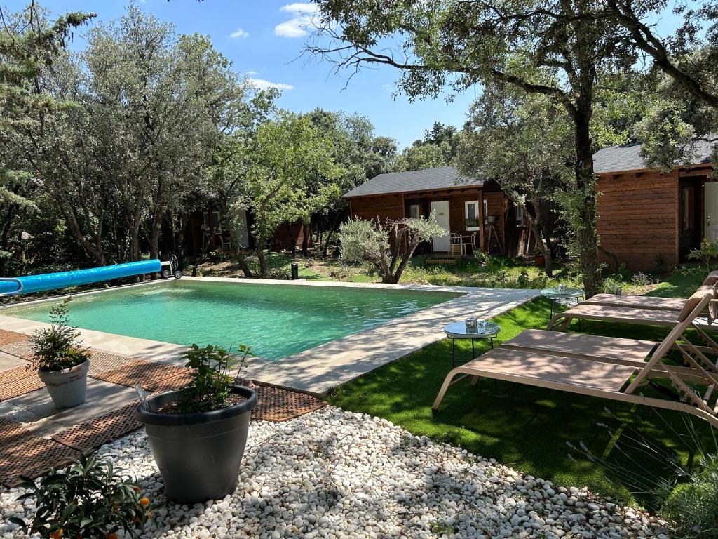 Venturada的住宿－Casa Rural de Rafael Cabañas de Madera，庭院内的游泳池,带长凳